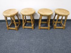A set of four circular pine stools
