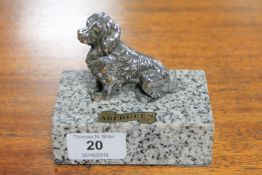 A chrome car mascot in the form of a spaniel,