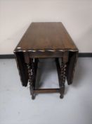 An oak pie crust edge gate leg table