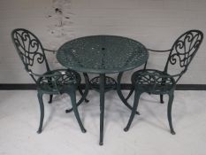 A circular patio table and two chairs