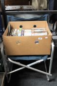 A folding camping chair together with a photographic enlarger and box containing assorted DVD's and