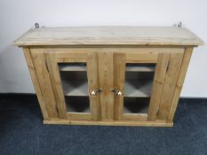 An antique pine glazed door cabinet