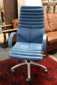 A blue leather adjustable office chair