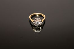 An 18ct gold diamond cluster ring, the central stone estimated at 0.