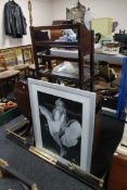 A framed monochrome print depicting Marilyn Monroe together with an Edwardian fire curb,