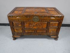 A mid twentieth century heavily carved camphor wood box