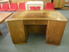 An early twentieth century mahogany shaped pedestal desk