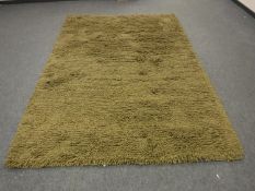 A hand knotted heavy quality green shaggy piled carpet RRP £681.00.
