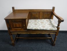 A carved oak telephone seat