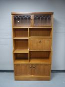 A mid twentieth century teak wall cabinet fitted with cupboard doors