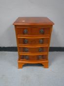 A reproduction yew wood four drawer chest
