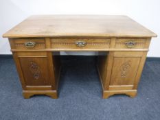 An early 20th century oak pedestal desk