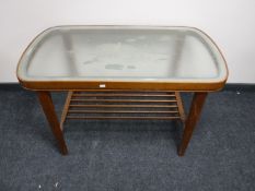 A mid 20th century Danish teak coffee table with glazed two-tone top