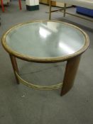 A mid century glass top circular table