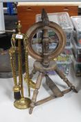 A brass four piece fire companion set together with an antique spinning wheel