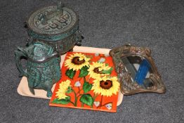A tray of Art Nouveau style mirror, glazed pottery wall plaque depicting sunflowers,