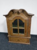 A continental light oak wall cabinet fitted a drawer