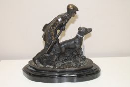 A spelter figure of a gamekeeper and a gun dog after Mene,
