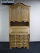A continental light oak bureau bookcase