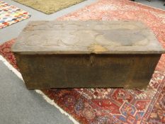 A nineteenth century oak shipping trunk with clover leaf detail to the lid