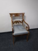 A 19th century mahogany scroll armchair