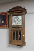 An Edwardian oak clock with calendar movement