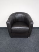 A brown leather tub chair