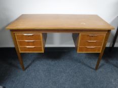 A mid 20th century teak desk fitted with six drawers