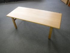 A contemporary light oak coffee table