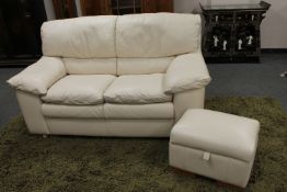 An Italian cream leather two seater settee,