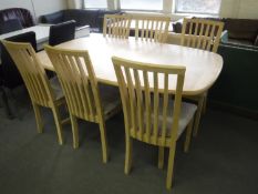 A light oak extending dining table and six chairs