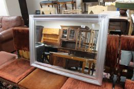 A silvered framed mirror