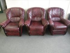 Three burgundy leather armchairs