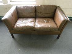 A late twentieth century brown leather twos eater settee