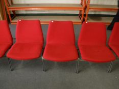 A set of seven Danish Duba office chairs upholstered in red fabric