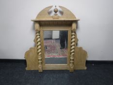 An antique light oak mirror with spiral supports