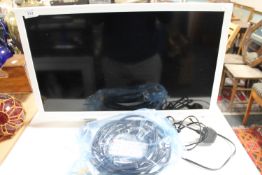 A Sharp 24 inch LCD TV with remote and lead