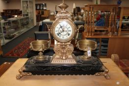 A nineteenth century ornate cast metal clock garniture,