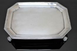 A Georgian silver card tray on paw feet.
