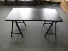 A black ash trestle table