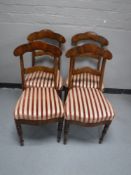 A set of four antique mahogany dining chairs upholstered in striped fabric