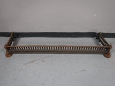 An antique cast iron fire curb
