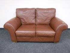 A brown leather two seater settee