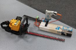 A petrol hedge trimmer,
