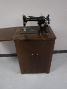 A Singer sewing machine table cabinet