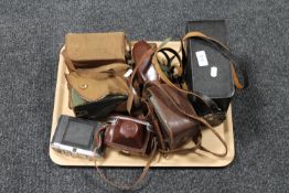 A tray of vintage cameras