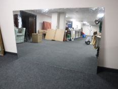 A large unframed mirror,