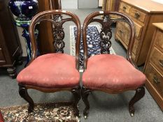 A pair of Victorian carved mahogany spoon back chairs.