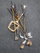 A quantity of vintage golf clubs together with a treble blue tennis racket