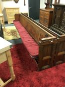 An early 20th century stained pine church pew, numbered 44,